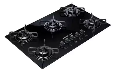 Cooktop 5 bocas com mesa de vidro preta, com queimador rápido ao centro e trempes de dois pontos de apoio.